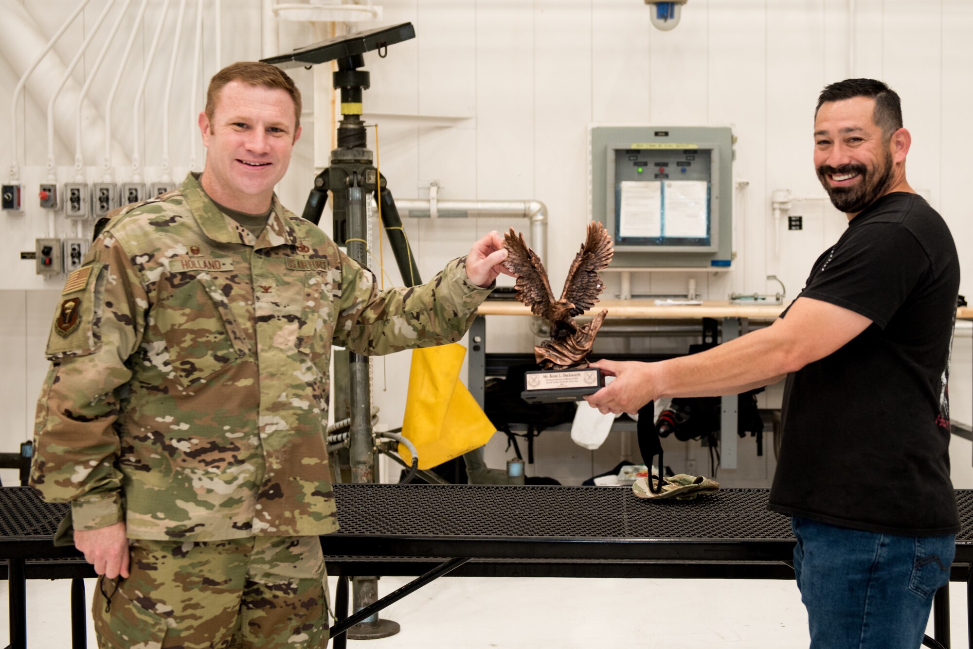 U.S. Air Force Col. Jeffrey Holland, 509th Maintenance Group commander, left, and Brent Duckworth, 509th MXG aircraft low observable structural maintenance technician, right, stands for photo with the Lt. Gen. Leo Marquez Award at Whiteman Air Force Base, Missouri, Aug. 14, 2020. Duckworth won the award in the Civilian Technician Aircraft Maintenance Category. This award recognizes military and civil service aircraft, munitions, and missile maintenance personnel who perform hands-on maintenance or manage a maintenance function. (U.S. Air Force photo by Airman 1st Class Christina Carter)