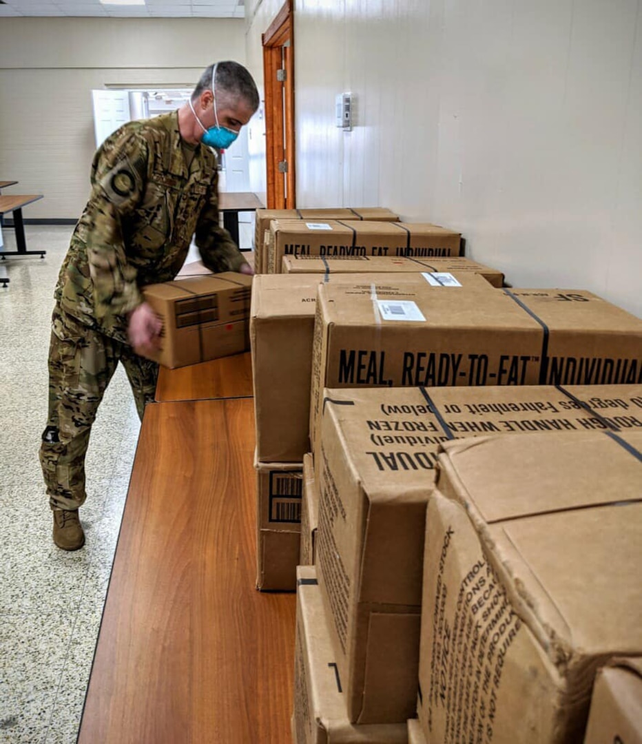 Members of the Texas National Guard help prepare supplies, including military rations, or meals ready to eat, in case they are needed in response to the expected arrival of Hurricane Laura Aug. 26-27, 2020.