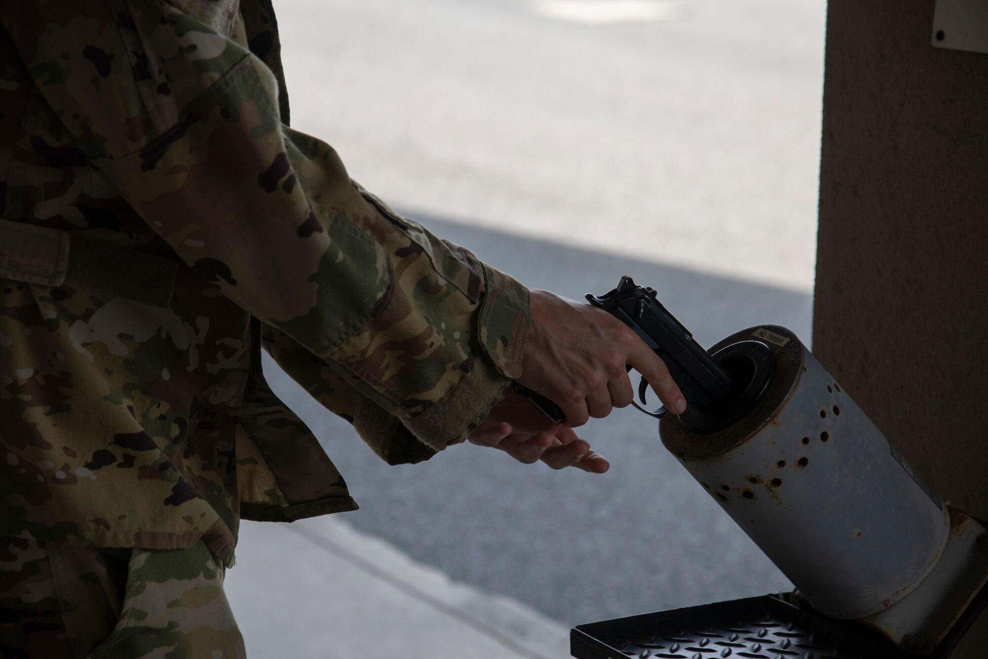 An Airman assigned to the 9th Airlift Squadron clears an M9 Beretta Aug. 20, 2020, at Dover Air Force Base, Delaware. Instead of crews going to the security forces armory, they can recieve their firearms from the Dover One Stop shop. (U.S. Air Force Photo by Airman 1st Class Jonathan Harding)