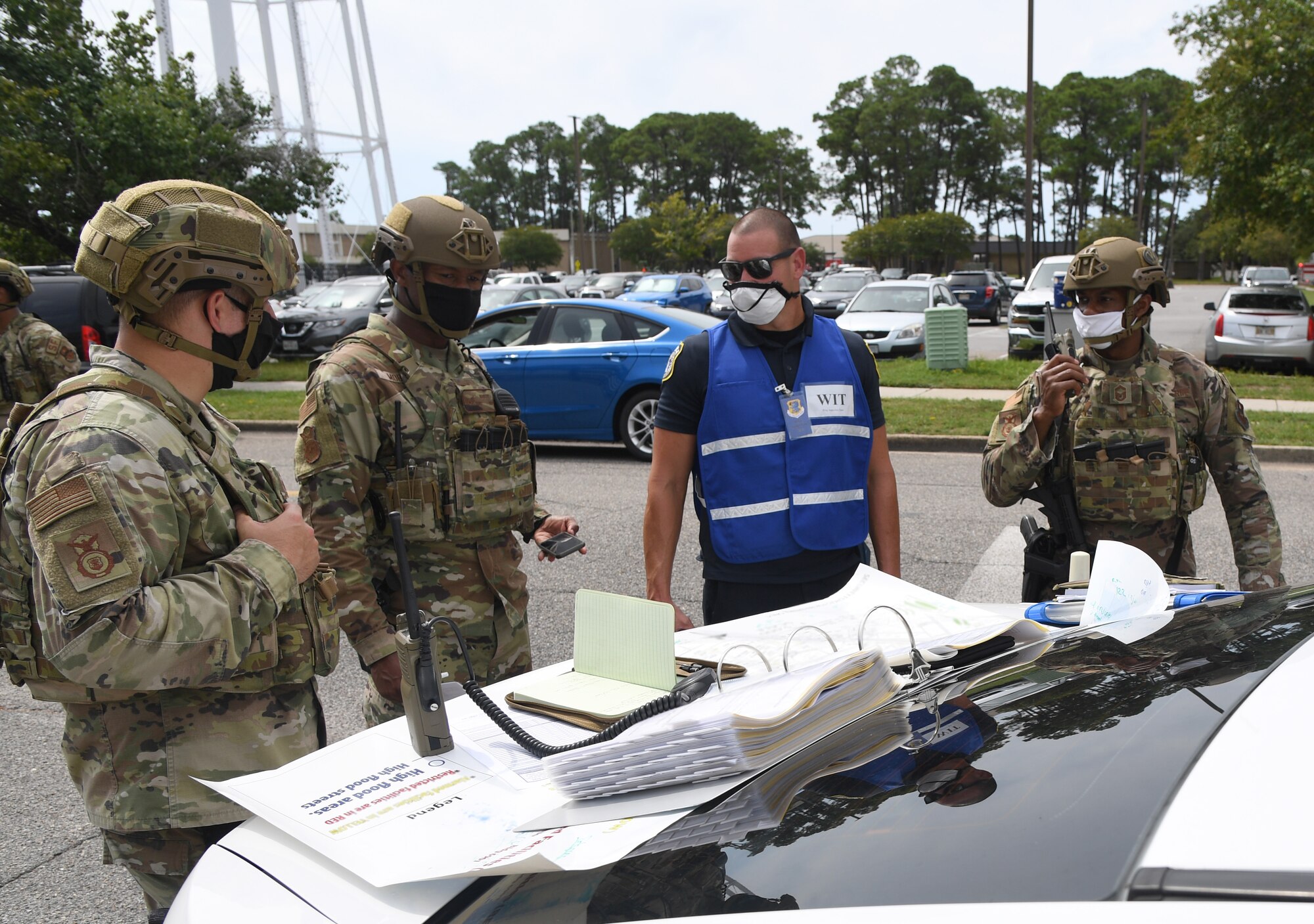 Members of the 81st Security Forces Squadron discuss the cordon perimeter during an active shooter exercise outside the Sablich Center at Keesler Air Force Base, Mississippi, Aug. 20, 2020. The scenario included two active duty Air Force members who simulated opening fire inside the Sablich Center in order to test the base's ability to respond to and recover from a mass casualty event. (U.S. Air Force photo by Kemberly Groue)