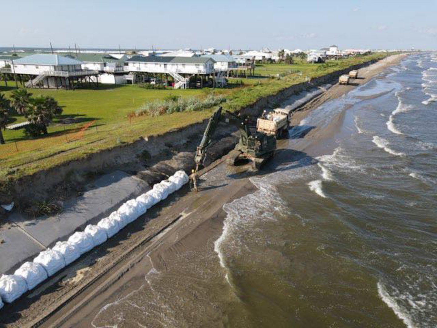 Members of the Louisiana National Guard's 843rd Engineer Company help local and state agencies reinforce the exposed burrito levee in Grand Isle before Tropical Storm Marco and Hurricane Laura. The hurricane was scheduled to make landfall Aug. 26-27, 2020.