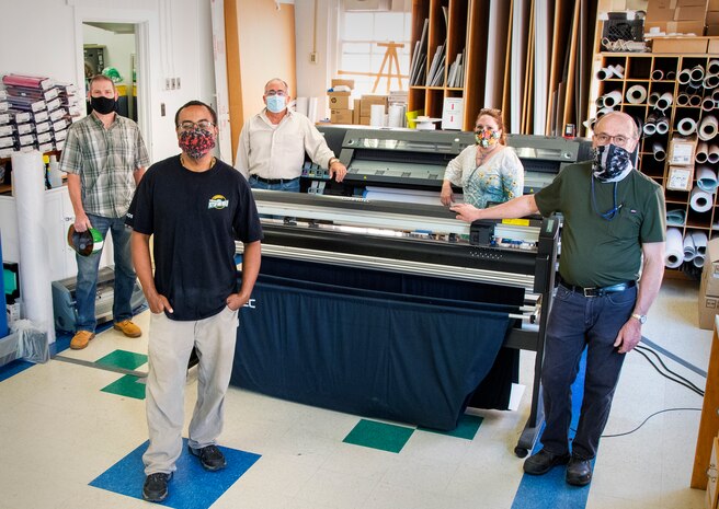 Employees assigned to Shop 71, Sign Shop, at Puget Sound Naval Shipyard & Intermediate Maintenance Facility work to produce signs as part of the shipyard's COVID-19 response and education efforts.