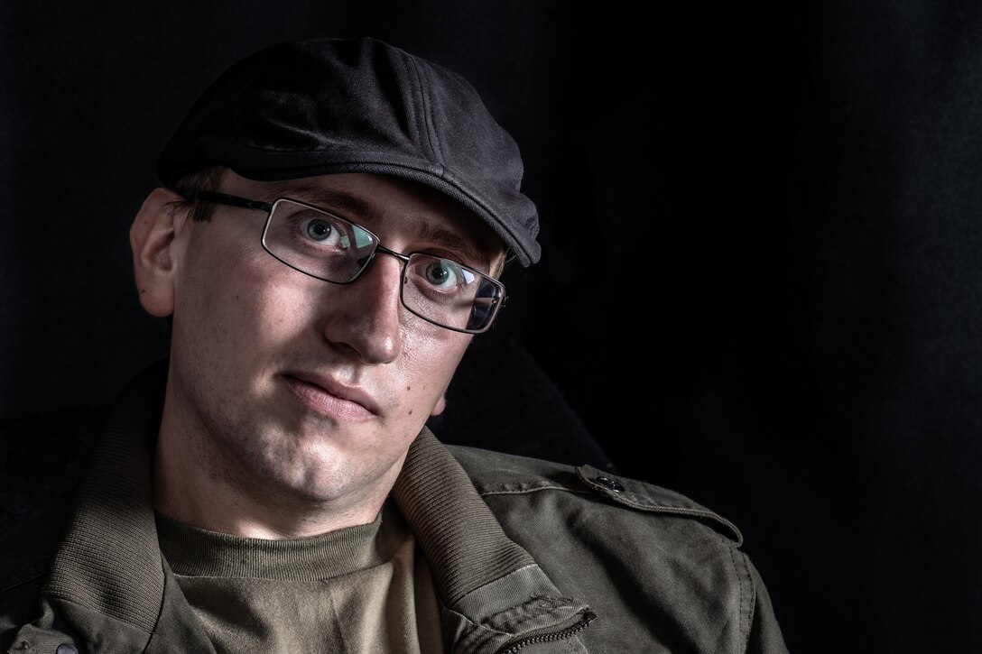 Senior Airman Noah Tancer, a public affairs specialist with the 910th Airlift Wing, poses for a photo on July 23, 2020, at Youngstown Air Reserve Station. Tancer is wearing a hat that he uses to express his love for British culture and style.