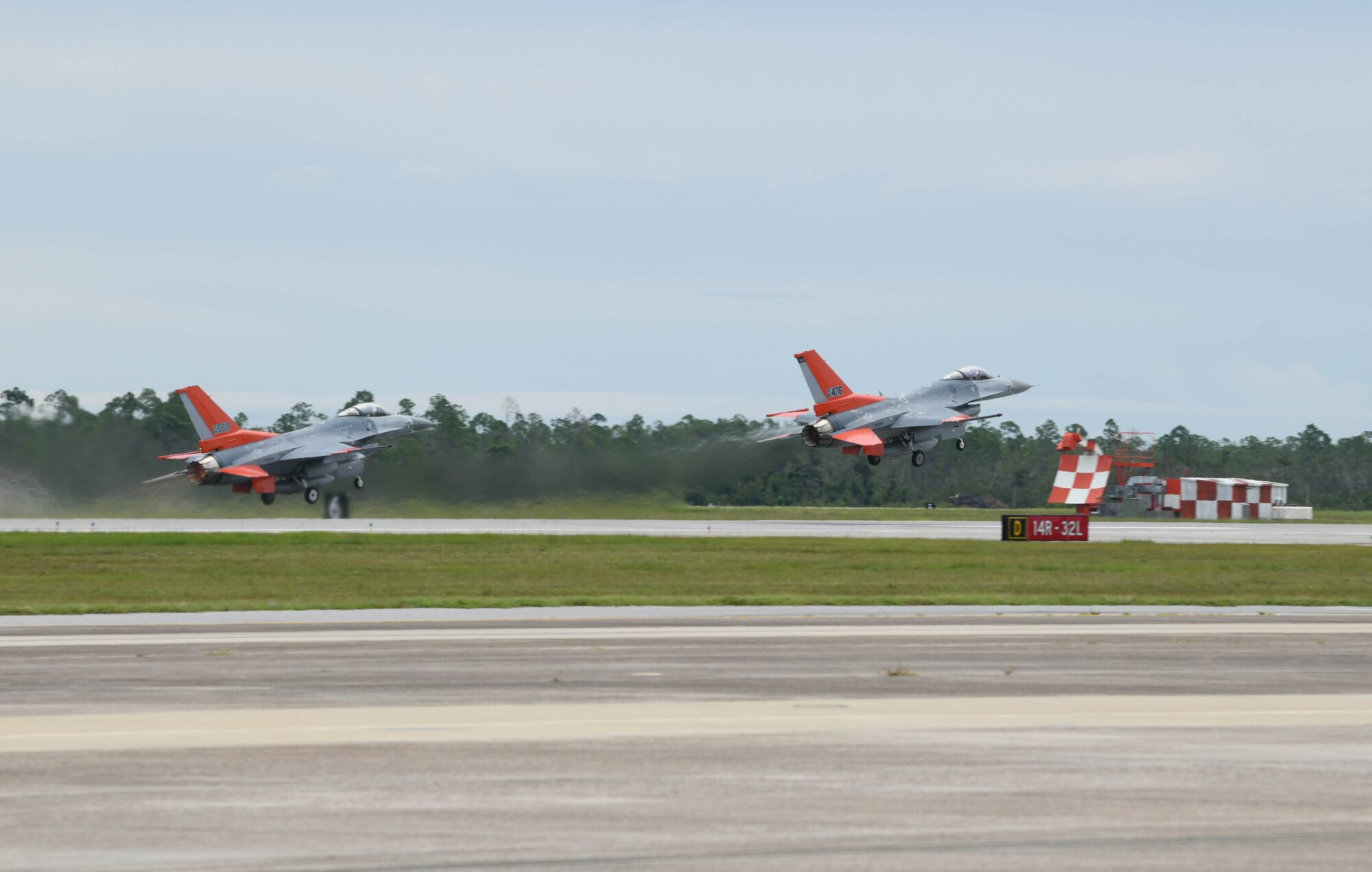 Two QF-16s from the 82nd Aerial Targets Squadron take off from Tyndall Air Force Base, Florida, Aug. 21, 2020. The aircraft evacuated from the 325th Fighter Wing’s airfield to Shaw Air Force Base, South Carolina, due to the possibility of severe weather conditions. (U.S. Air Force photo by Airman Anabel Del Valle)