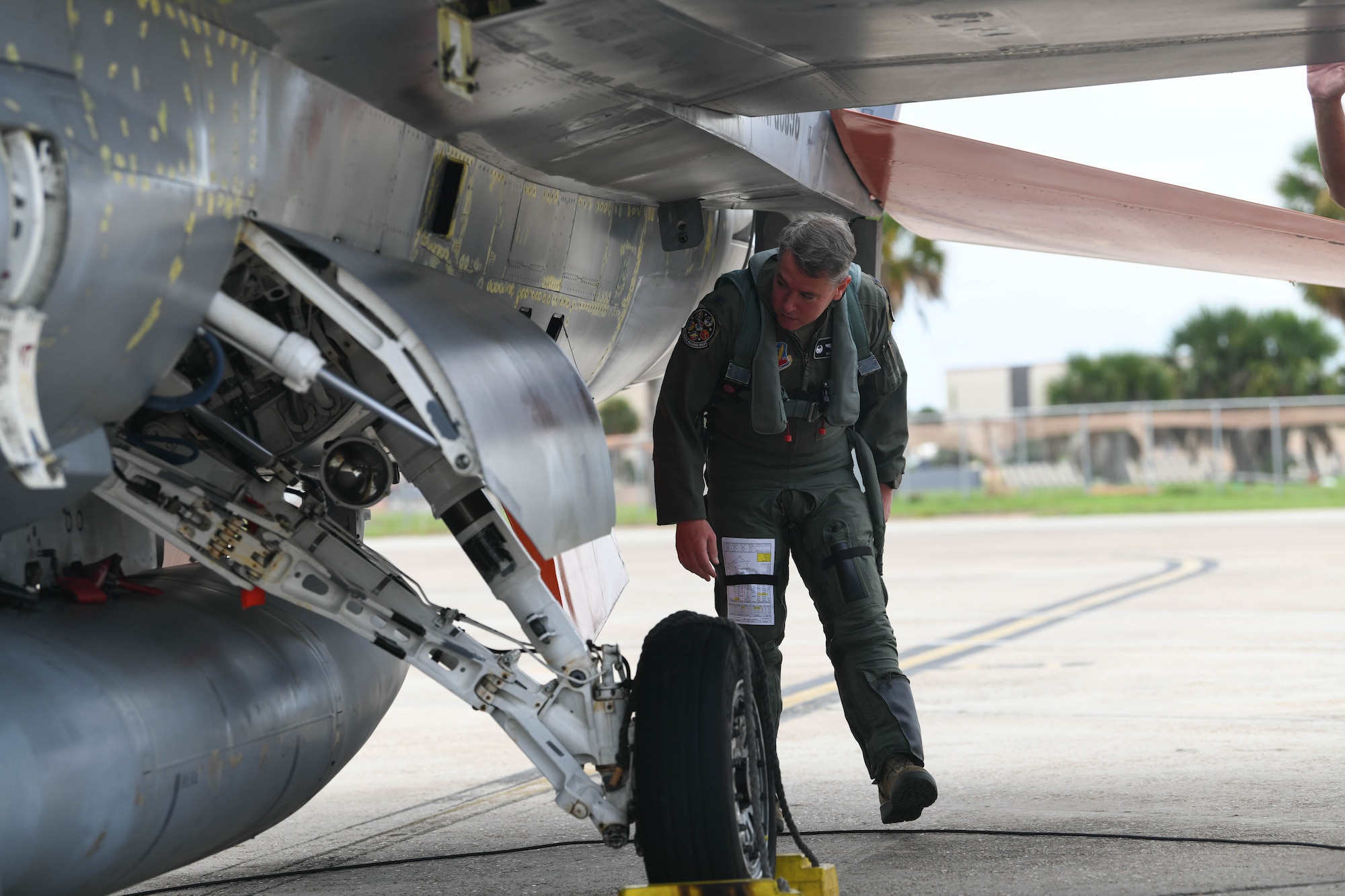 U.S. Air Force Col. Nicholas Reed with the 53rd Weapons Evaluation Group, commander, performs pre-flight checks of a QF-16 before takeoff at Tyndall Air Force Base, Florida, Aug. 21, 2020. The unit evacuated multiple aircraft to from the 325th Fighter Wing’s airfield to Shaw Air Force Base, South Carolina, for safe haven from severe weather conditions. (U.S. Air Force photo by Airman Anabel Del Valle)