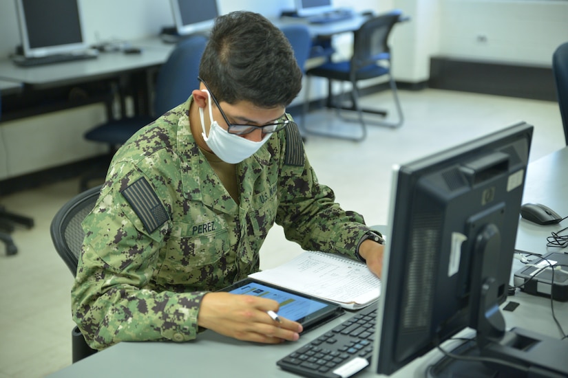 A man works on a computer.