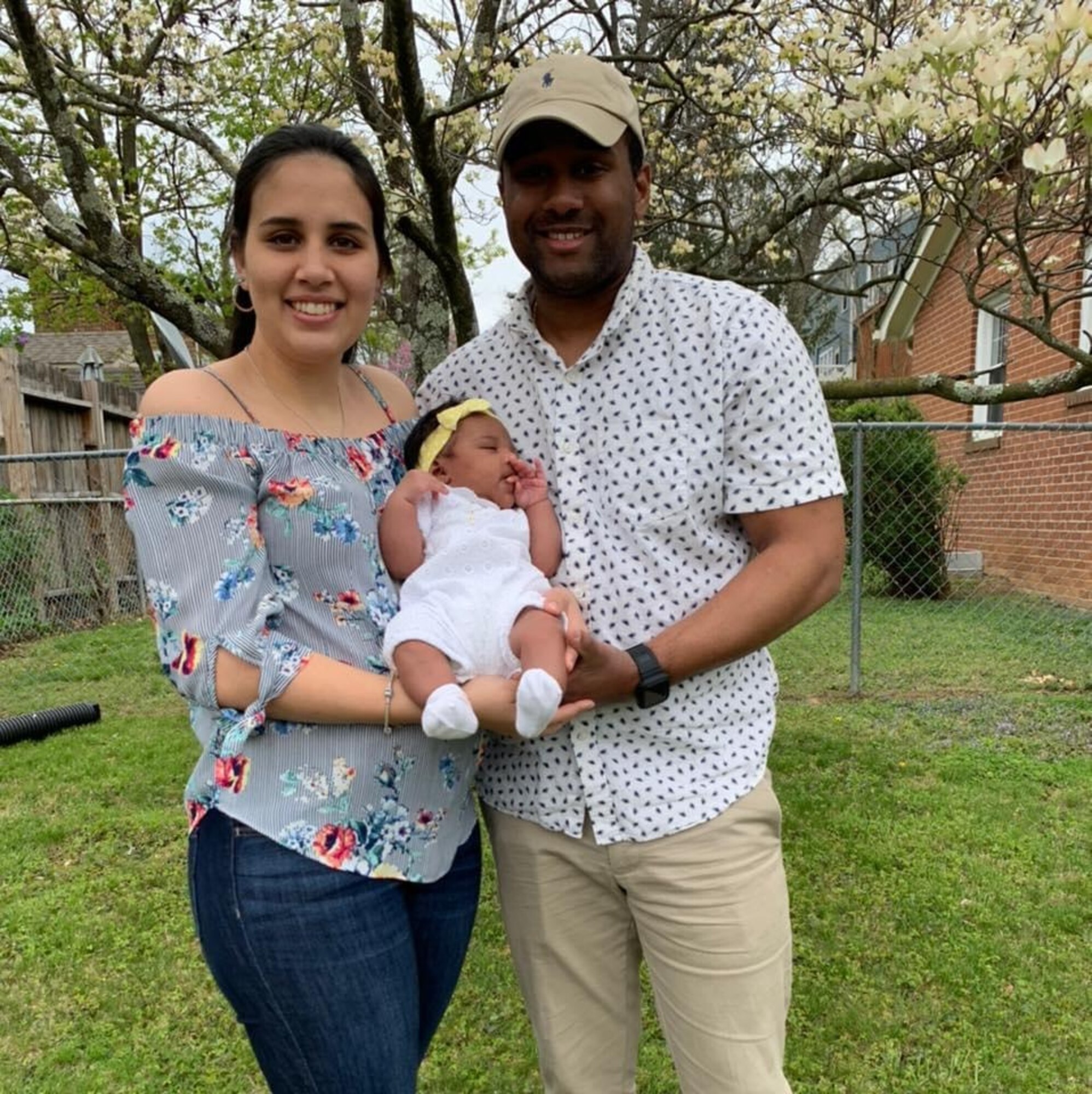 A man and a woman hold a baby