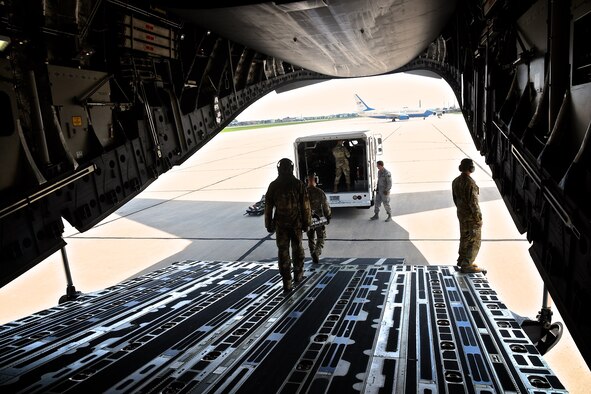 Mission success:  The 932nd Airlift Wing's Aeromedical Evacuation Squadron (AES), members return from flying a busy medical training flight August 23, 2020, at Scott Air Force Base, Ill.. The reserve Citizen Airmen trained two days on a C-17 aircraft, provided by the 445th Airlift Wing, a reserve unit visiting from Wright Patterson Air Force Base, Ohio. The aeromedical training featured interaction and communication between local medical personnel and the aircrew, checking equipment, and reacting to training scenarios in the air with simulated patients. The wing's C-40 airplane sits in the background waiting on another mission.  (U.S. Air Force photo by Lt. Col. Stan Paregien)