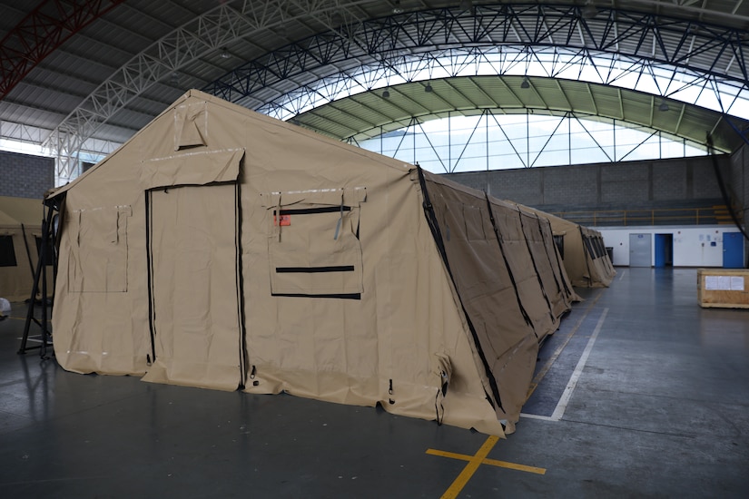A field hospital on display in a hangar.