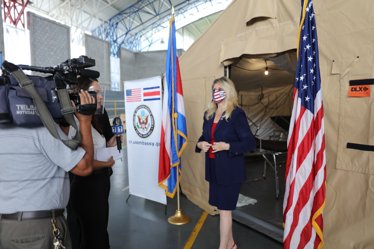 Ambassador Sharon Day stands outside a field hospital and talks to the media.