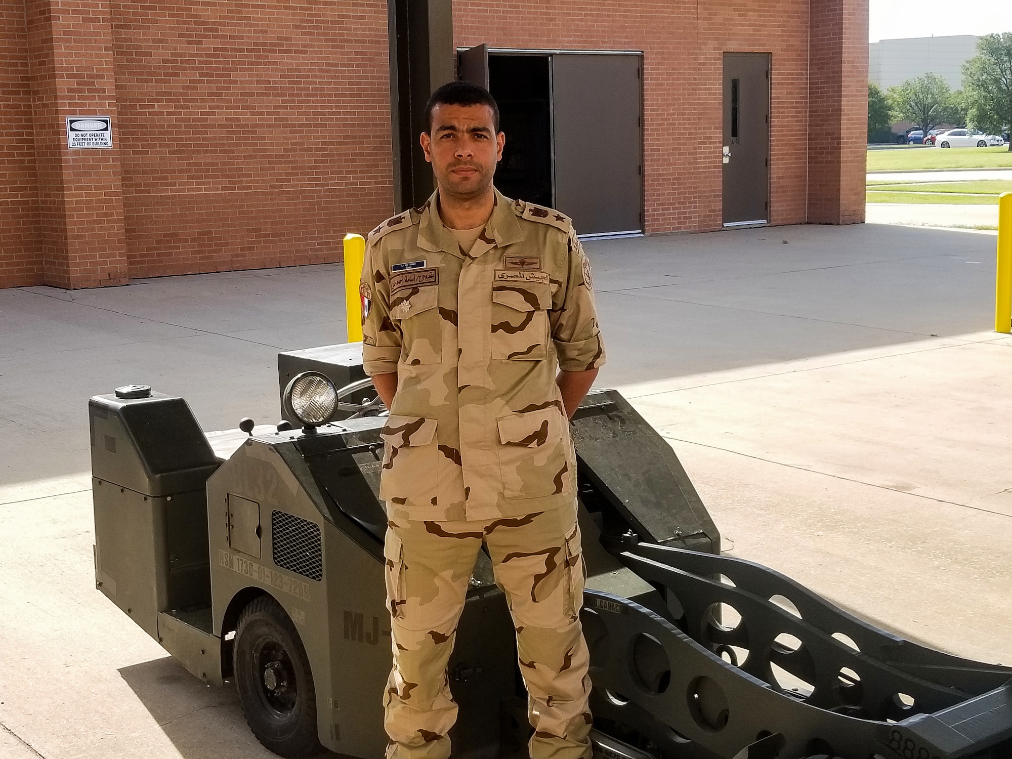 Lt. Col. Osama A. Khalil of the Egyptian air force stands in from of an MJ-1 jammer bomb loader