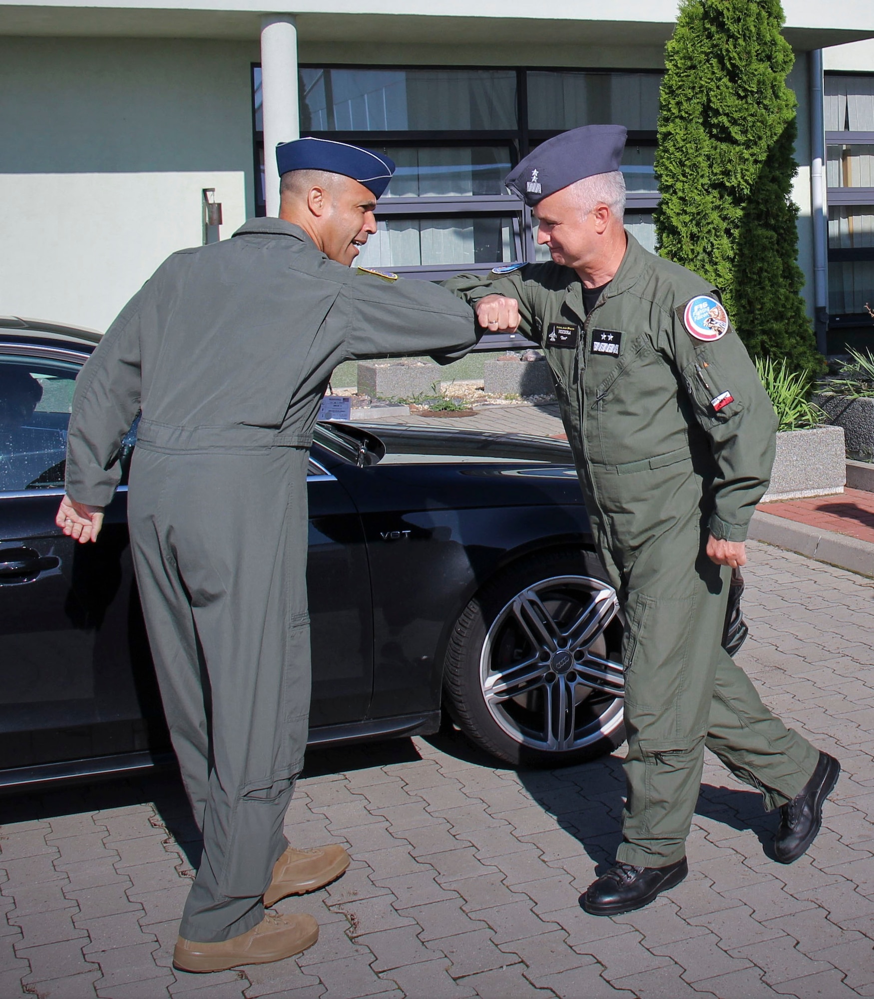 U.S. Air Force Brig. Gen. Adrian Spain, United States Air Forces in Europe and Air Forces Africa director of plans, programs and analyses, left, and  Polish air force Maj. Gen. Jacek Pszczoła, inspector of the Polish air force, bump elbows in place of handshakes during a tour of the 32nd Tactical Air Base, August 24, 2020, at Łask AB, Poland. The U.S. values the bilateral relationship with Poland and continues to share perspectives, train on missions and learn from each other. (Photo courtesy of the 32nd Tactical Air Base)