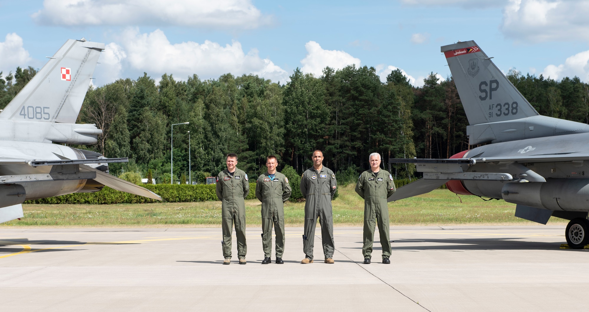 Starting far left, Polish air force Col. Tomasz Jatczak, 32nd Tactical Air Base commander, Brig. Gen. Iteneusz Nowak, 2nd Tactical Air Wing commander, U.S. Air Force Brig. Gen. Adrian Spain, United States Air Forces in Europe and Air Forces Africa director of plans, programs and analyses, and Polish air force Maj. Gen. Jacek Pszczoła, inspector of the Polish air force, pose in front of a static display, August 24, 2020, at Łask AB, Poland. The U.S. and Polish partnership is critical in light of growing security challenges, and opportunities to share perspectives and integrate help strengthen this relationship. (U.S. Air Force photo by Senior Airman Melody W. Howley)