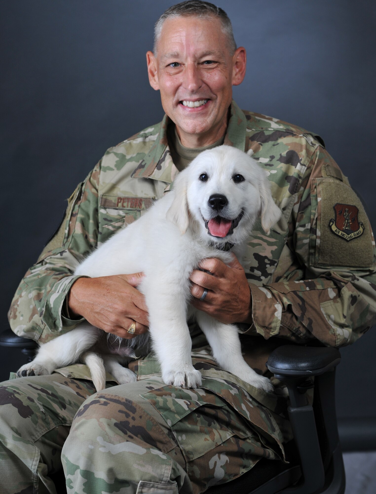 Lt. Col. Steve Peters, 185th Air Refueling Wing chaplain, with his dog, Lincoln, at the Iowa Air National Guard unit in Sioux City, Iowa, Aug. 13, 2020. Lincoln is an English Cream Golden Retriever puppy training to become a therapy dog at the Iowa Air Guard unit.