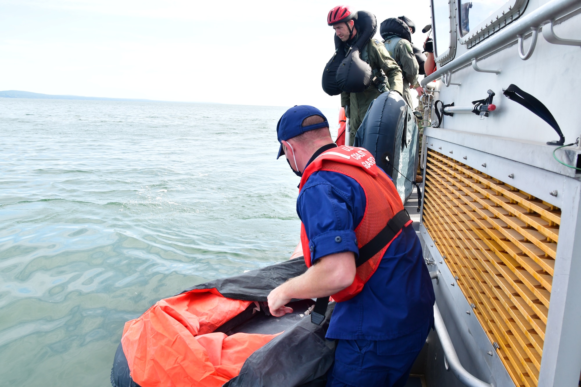 Personnel from U.S. Coast Guard Station Duluth, aboard an RBM-45628, participate in a water survival and rescue training event alongside F-16 pilots from the 148th Fighter Wing, Minnesota Air National Guard.