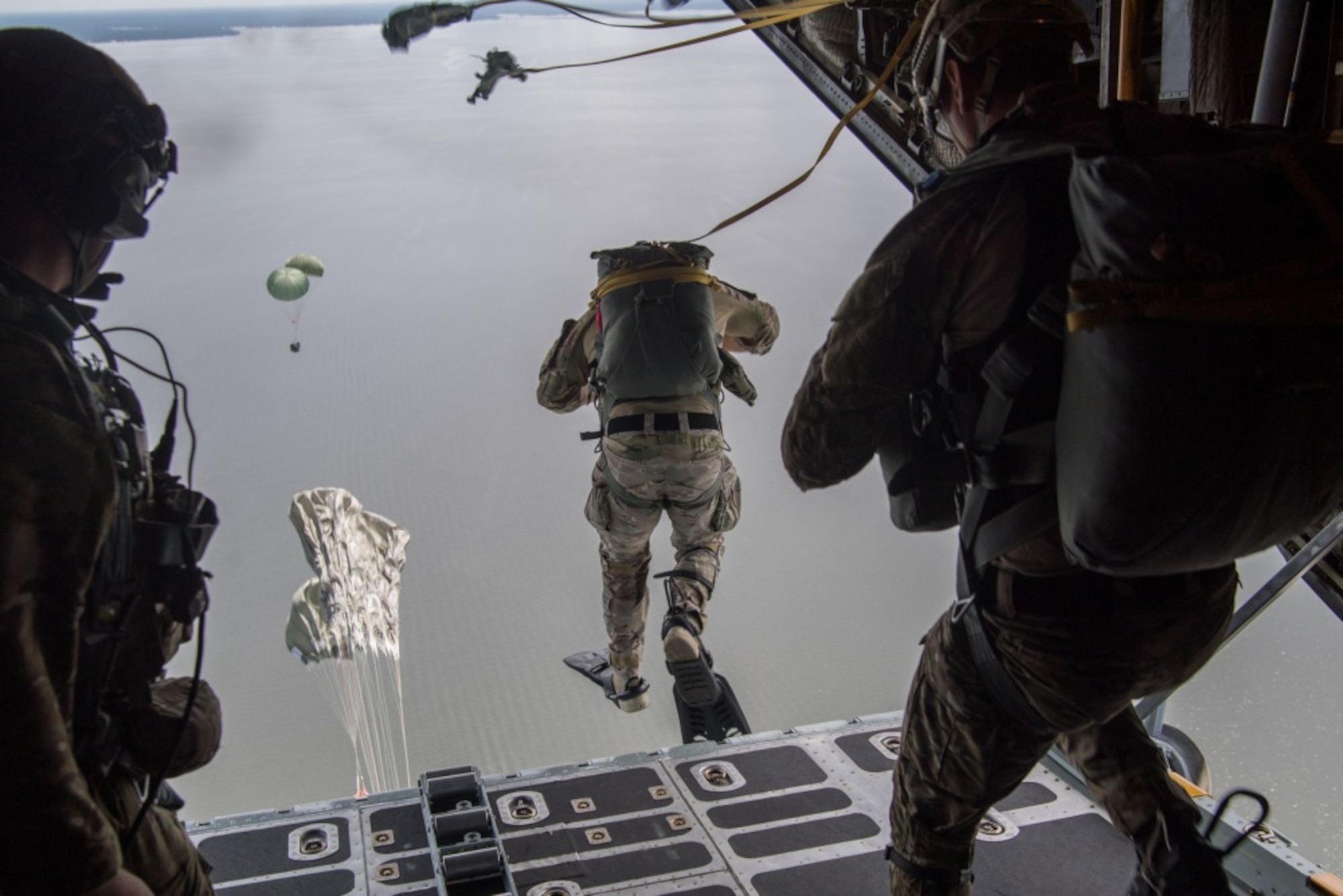 image of an Air Force Special Tactics operator jumping out the back of an aircraft into the water
