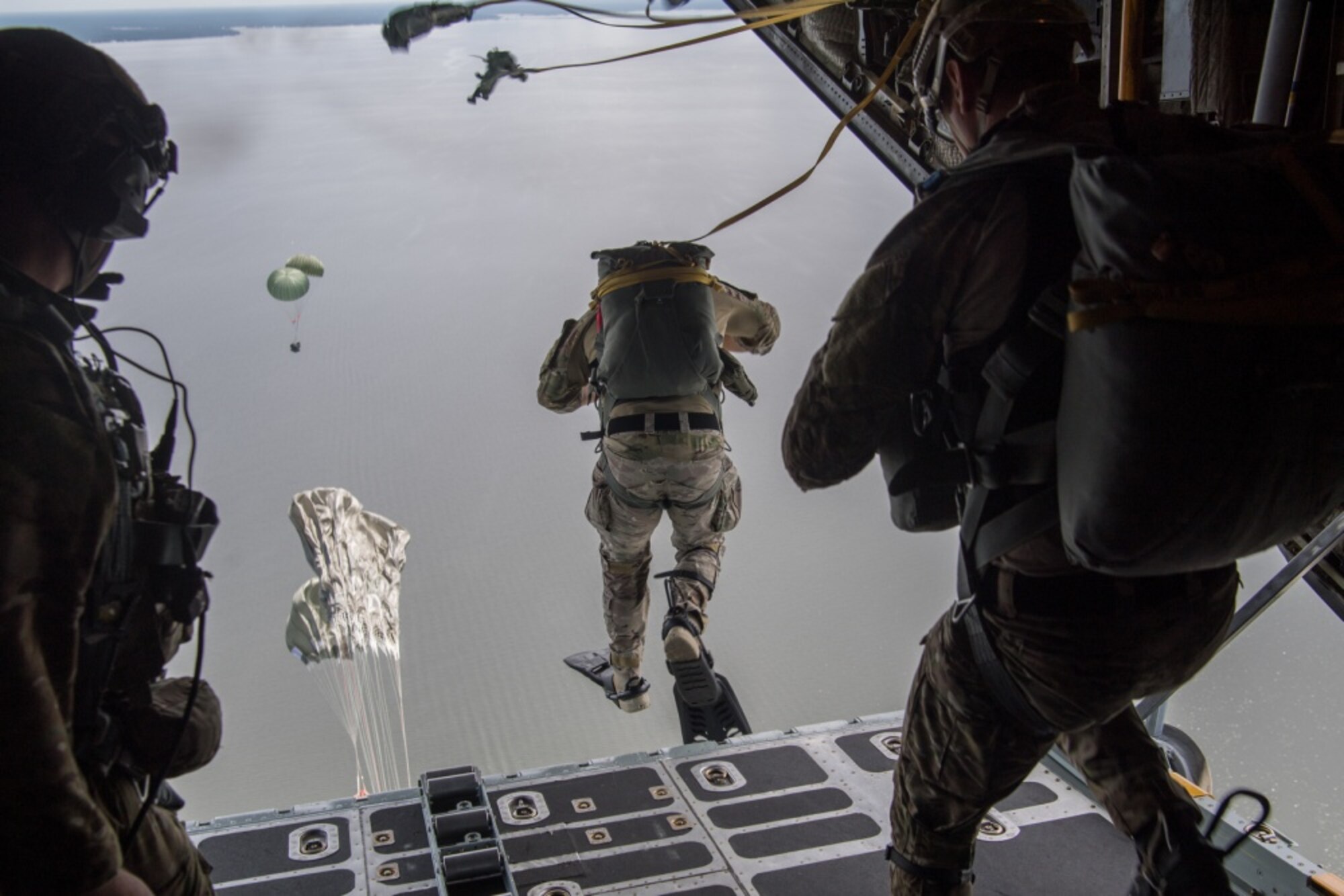 image of an Air Force Special Tactics operator jumping out the back of an aircraft into the water