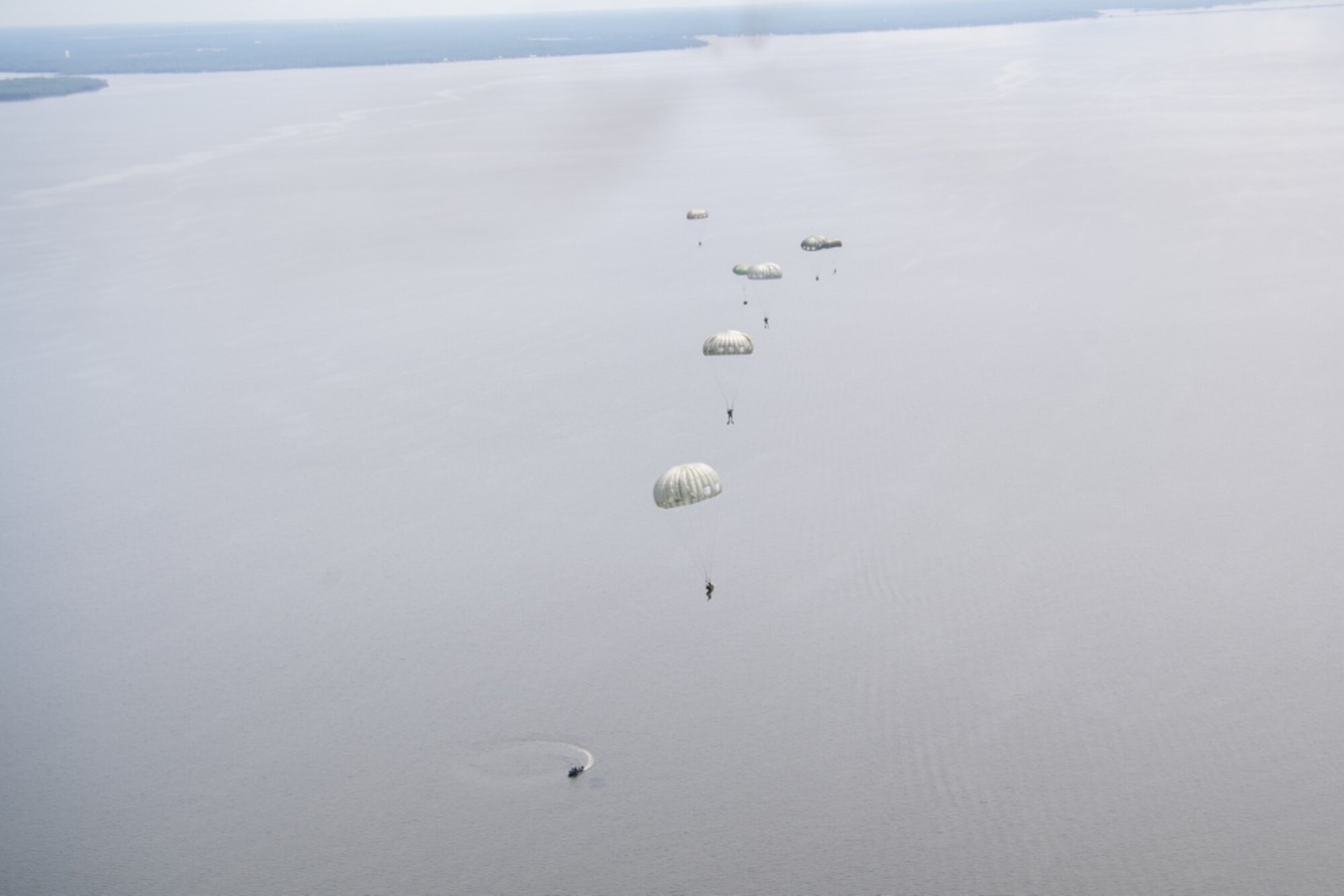 image of air force special tactics operators parachuting into the ocean for training