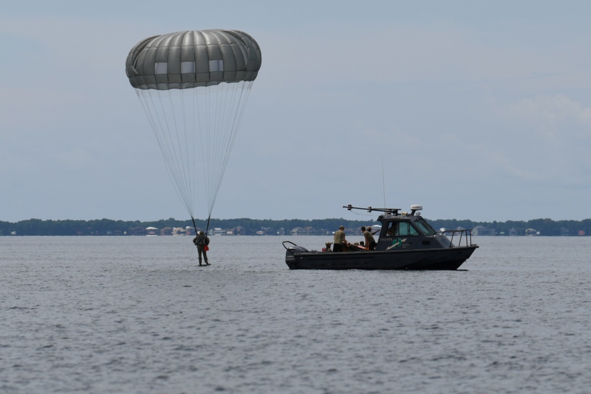 Image of an Air Force Special Tactics operator landing in the water after performing a static line parachute jump