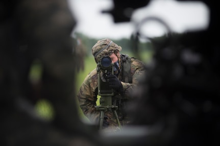 Spc. Nathaniel Harris, a Mustang, Oklahoma, resident and a cannon crewmember with Battery B, 1st Battalion, 160th Field Artillery Regiment, 45th Infantry Brigade Combat Team, adjusts a collimator for a 105mm howitzer during crew drill training at the unit's armory in Holdenville, Oklahoma, July 29, 2020. The Soldiers, along with other units of the 45th IBCT, are taking part in home-station annual training with limited field training exercises while implementing COVID-19 counter measures like social distancing or wearing masks when social distancing is not possible - such as during crew drills. (Oklahoma Army National Guard photo by Sgt. Anthony Jones)