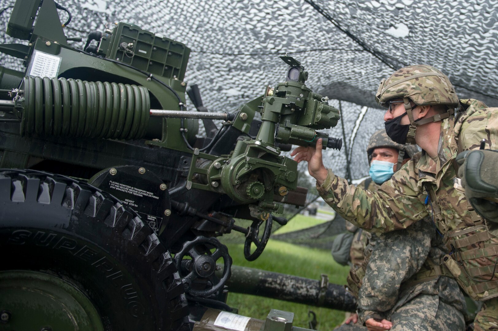 Soldiers from Battery B, 1st Battalion, 160th Field Artillery Regiment, 45th Infantry Brigade Combat Team, conduct crew drills with a 105mm Howitzer at their home armory in Holdenville, Oklahoma, July 29, 2020. The Soldiers, along with other units of the 45th IBCT, are taking part in home-station annual training with limited field training exercises while implementing COVID-19 counter measures like social distancing or wearing masks when social distancing is not possible - such as during crew drills. (Oklahoma Army National Guard photo by Sgt. Anthony Jones)