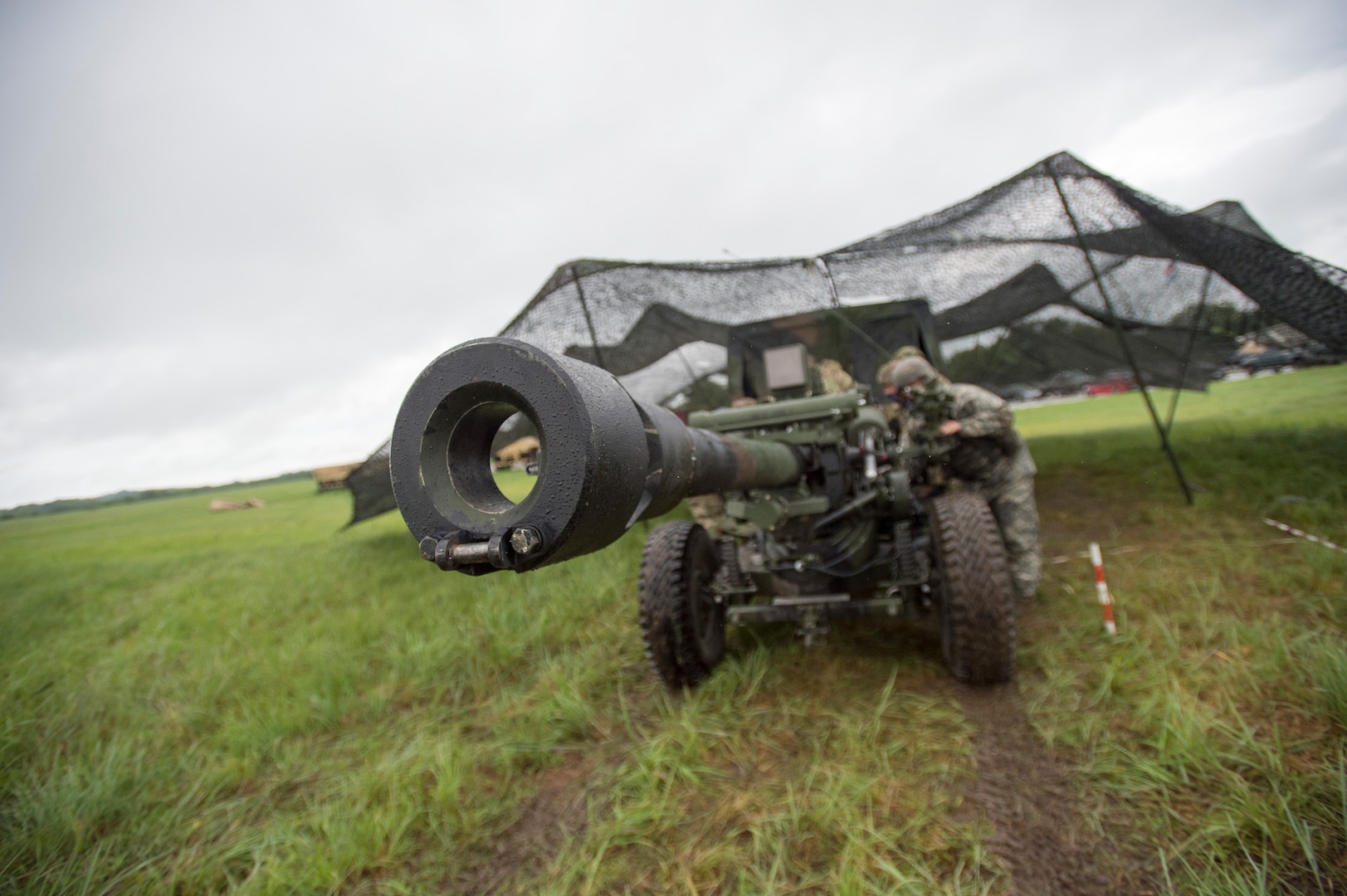 Soldiers from Battery B, 1st Battalion, 160th Field Artillery Regiment, 45th Field Infantry Brigade Combat Team, prepare to emplace a 105mm Howitzer during crew drill training at the Battery's home armory in Holdenville, Oklahoma, July 29, 2020. The Soldiers, along with other units of the 45th IBCT, are taking part in home-station annual training with limited field training exercises while implementing COVID-19 counter measures like social distancing or wearing masks when social distancing is not possible - such as during crew drills. (Oklahoma Army National Guard photo by Sgt. Anthony Jones)