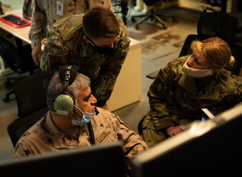 Col. Abdallah Ali Mohamed Al-Bloushi, United Arab Emirates Air Operations Center deputy commander, discuss operations with Col. Kristen Thompson, 380th Expeditionary Operations Group commander, and Capt. Christopher Dunn 727th Expeditionary Air Control Squadron section mission planning chief during a visit to the 727th EACS headquarters (Kingpin), August 24, 2020, in Al Dhafra Air Base, United Arab Emirates.