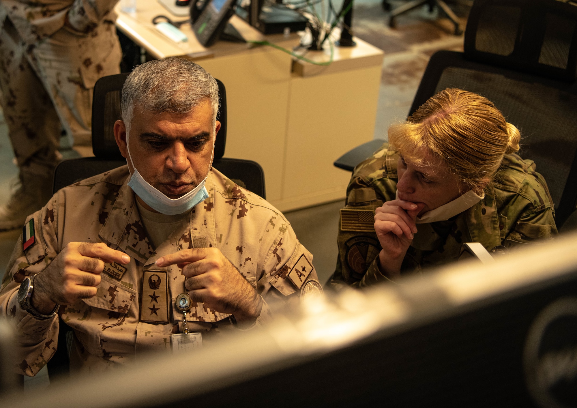 Col. Abdallah Ali Mohamed Al-Bloushi, United Arab Emirates Air Operations Center deputy commander, discuss operations with Col. Kristen Thompson, 380th Expeditionary Operations Group commander, during a visit to the 727th Expeditionary Air Control Squadron headquarters (Kingpin), August 24, 2020, in Al Dhafra Air Base, United Arab Emirates.