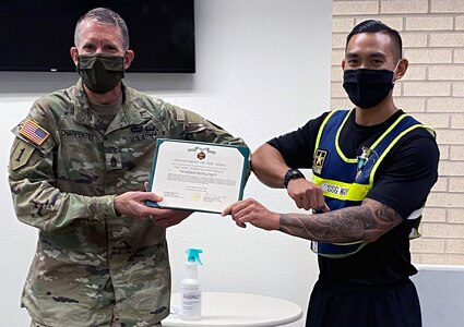 Command Sgt. Major Clark Charpentier presents Staff Sgt. Michael Nguyen, the U.S. Army Medical Center of Excellence 2020 Best Warrior Noncommissioned Officer, with his official award during an informal awards ceremony at Joint Base San Antonio-Fort Sam Houston.