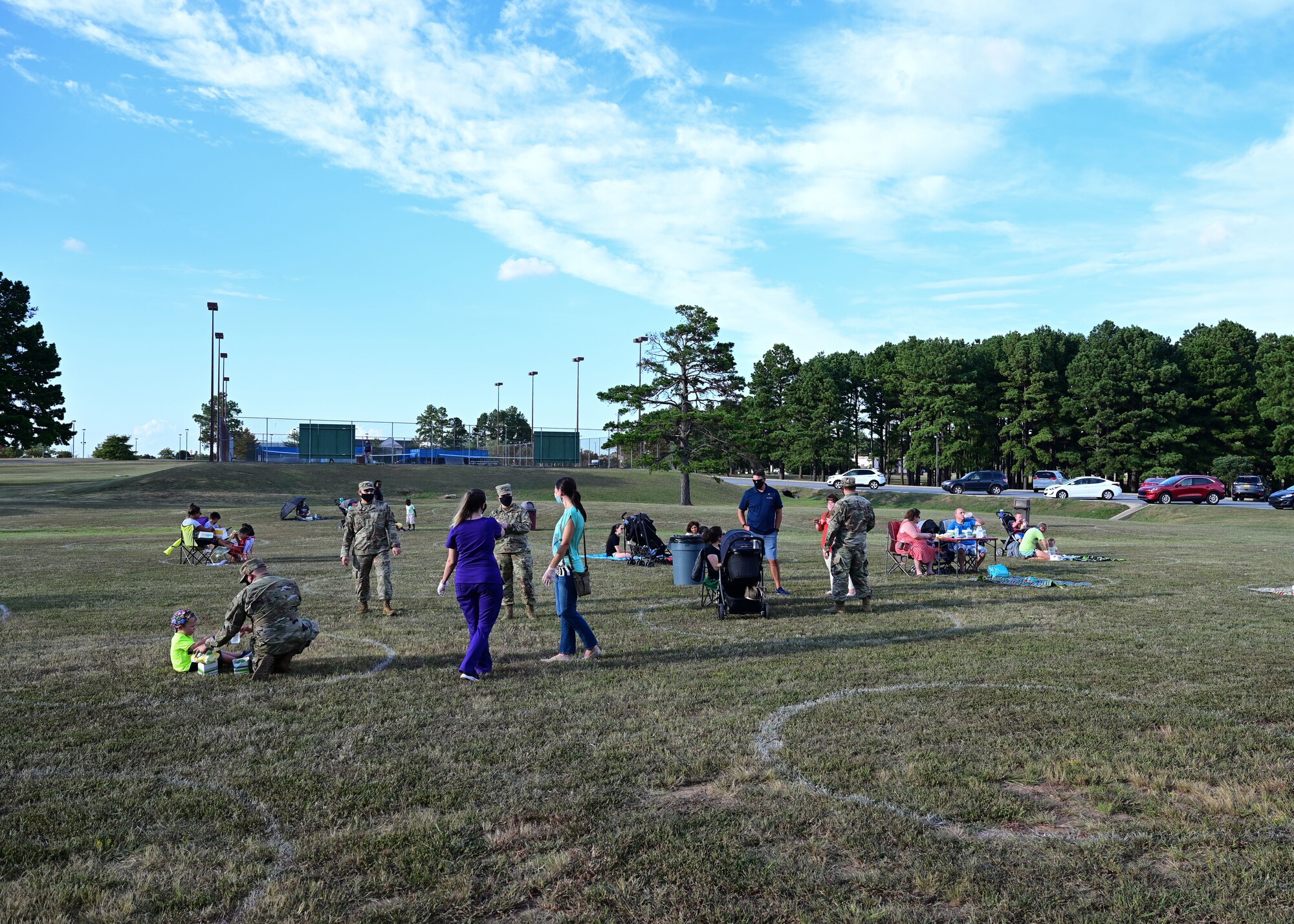 Families enjoy a base picnic in the park