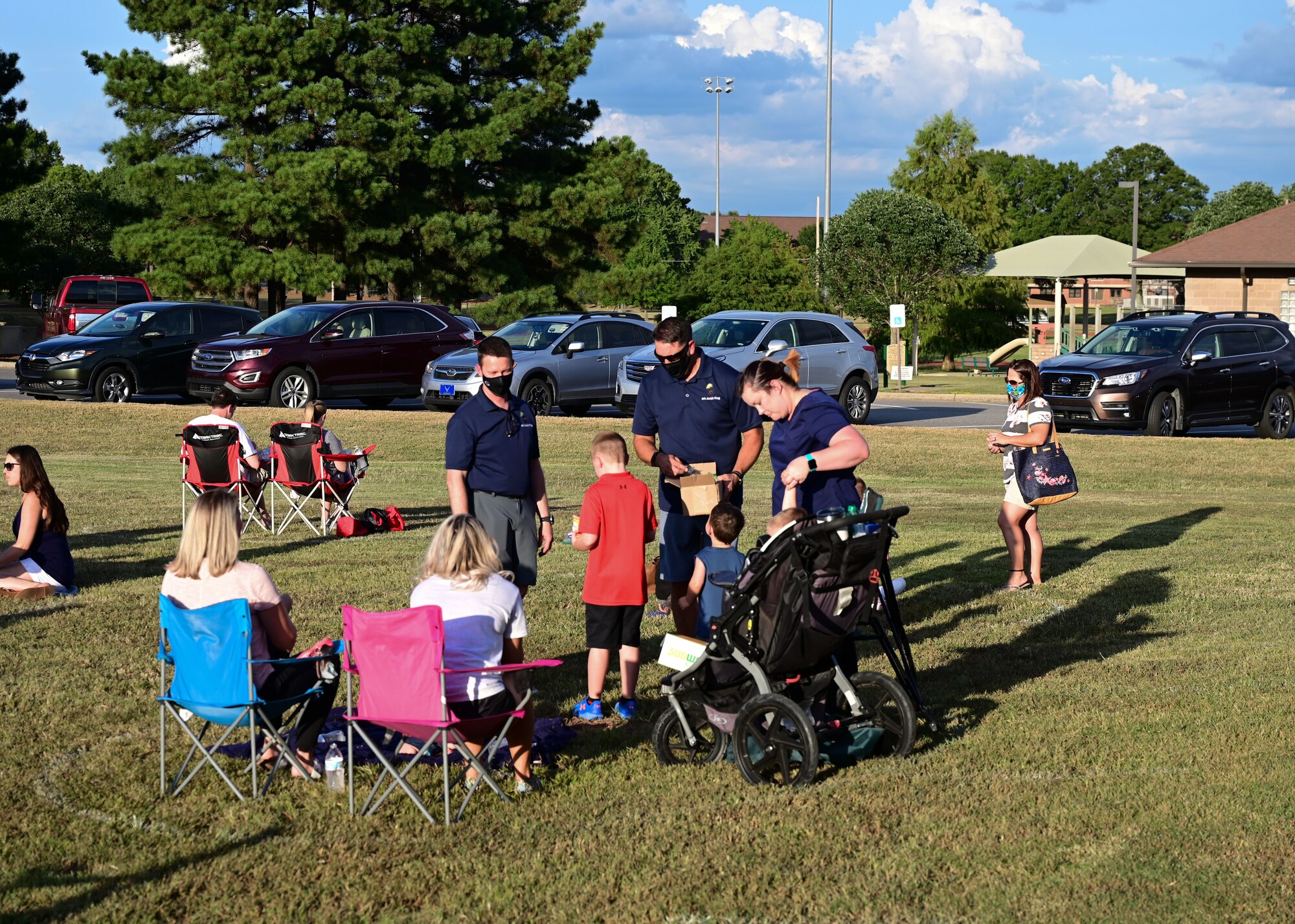 Families sit together during a picnic
