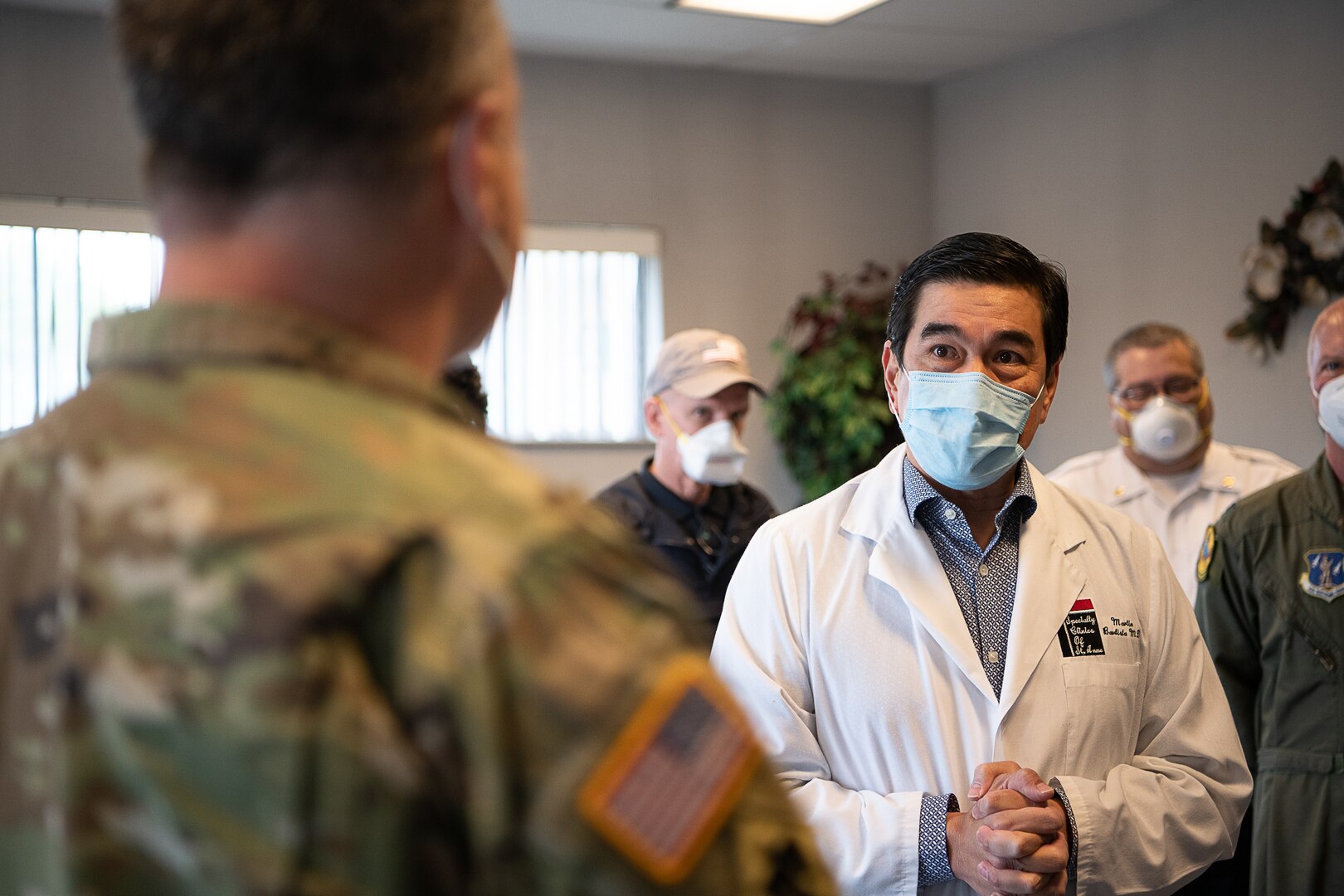 Dr. Martin Bautista, a physician at the Memorial Hospital of Texas County in Guymon, Oklahoma, welcomes members of the Oklahoma Army and Air National Guard, Centers for Disease Control and Prevention, the Oklahoma State Department of Health, Oklahoma State University laboratories, and the Federal Emergency Management Agency, during a visit to the hospital, May 15, 2020. As of May 19, 2020, Guymon had 650 confirmed cases of COVID-19, making it second in the total number of cases in Oklahoma. Oklahoma City, which has the highest number of COVID-19 cases, has the largest population of any city in Oklahoma, Guymon is 40th. Beginning at the Memorial Hospital of Texas County, which has been seeing an average of three to four COVID-19 patients a day, and then moving on to the Texas County Health Department and the Seaboard Foods pork processing plant, the group focused on creating solutions to issues such as facility layouts, and supply, resources, and staffing shortages. (Oklahoma Air National Guard photo by Tech. Sgt. Kasey M. Phipps)