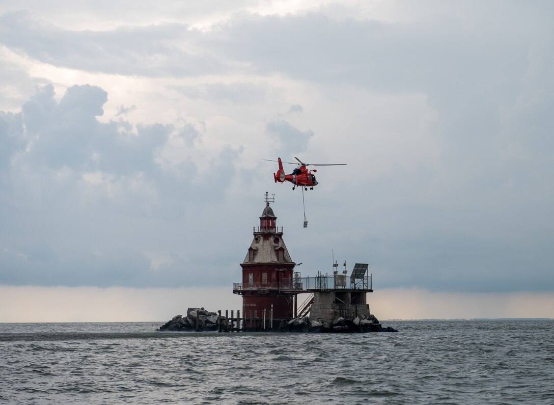 The Aids to Navigation Team in Cape May replaces a battery in an offshore lighthouse, Aug. 12, 2020. Crew members from ANT Cape May traveled to the lighthouse to install a new battery provided by an Air Station Atlantic City HH-65 Dolphin helicopter crew. The ANT team installed the battery into the lighthouse after breaking down the wiring and removing the old battery and ensured the light was operational.