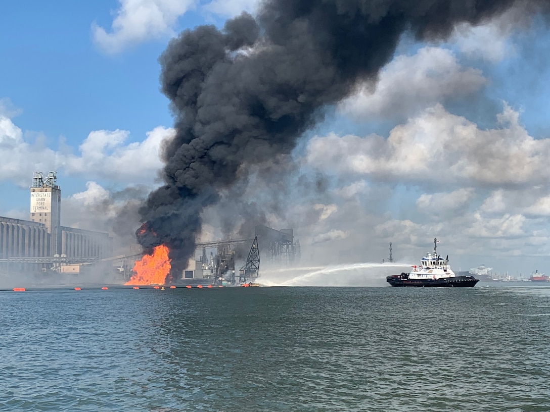 Coast Guard crews respond to a dredge on fire in the Port of Corpus Christi Ship Channel, Aug. 21, 2020. A Sector/Air Station Corpus Christi MH-65 Dolphin helicopter crew was launched to the scene, hoisted two injured crewmembers and transferred them to Corpus Christi Medical Center - Bay Area.