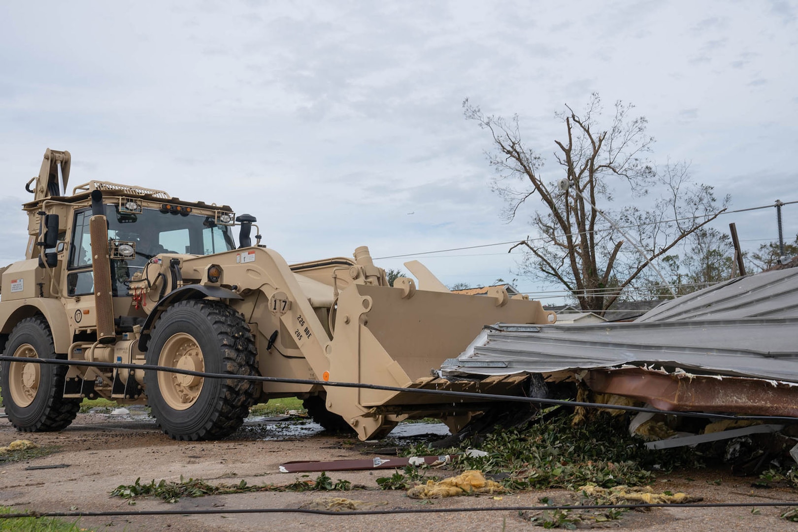 As the sun rises over Southwest Louisiana Aug. 27, 2020, members of the Louisiana National Guard clear roadways in Lake Charles and begin to assess the damage from Hurricane Laura.