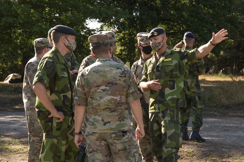 Swedish soldiers, assigned to the Air Defence Regiment, visit U.S. Soldiers assigned to the 5th Battalion, 7th Air Defense Artillery Regiment, 10th Army Air and Missile Defense Command, in Baumholder training Area, Germany