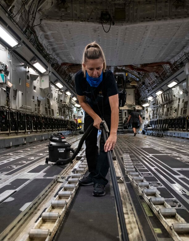 Aircraft attendants clean the inside of a C-17 Globemaster III.
