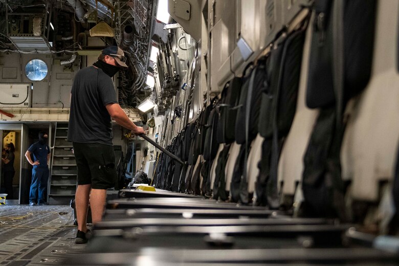Aircraft attendants clean the inside of a C-17 Globemaster III.