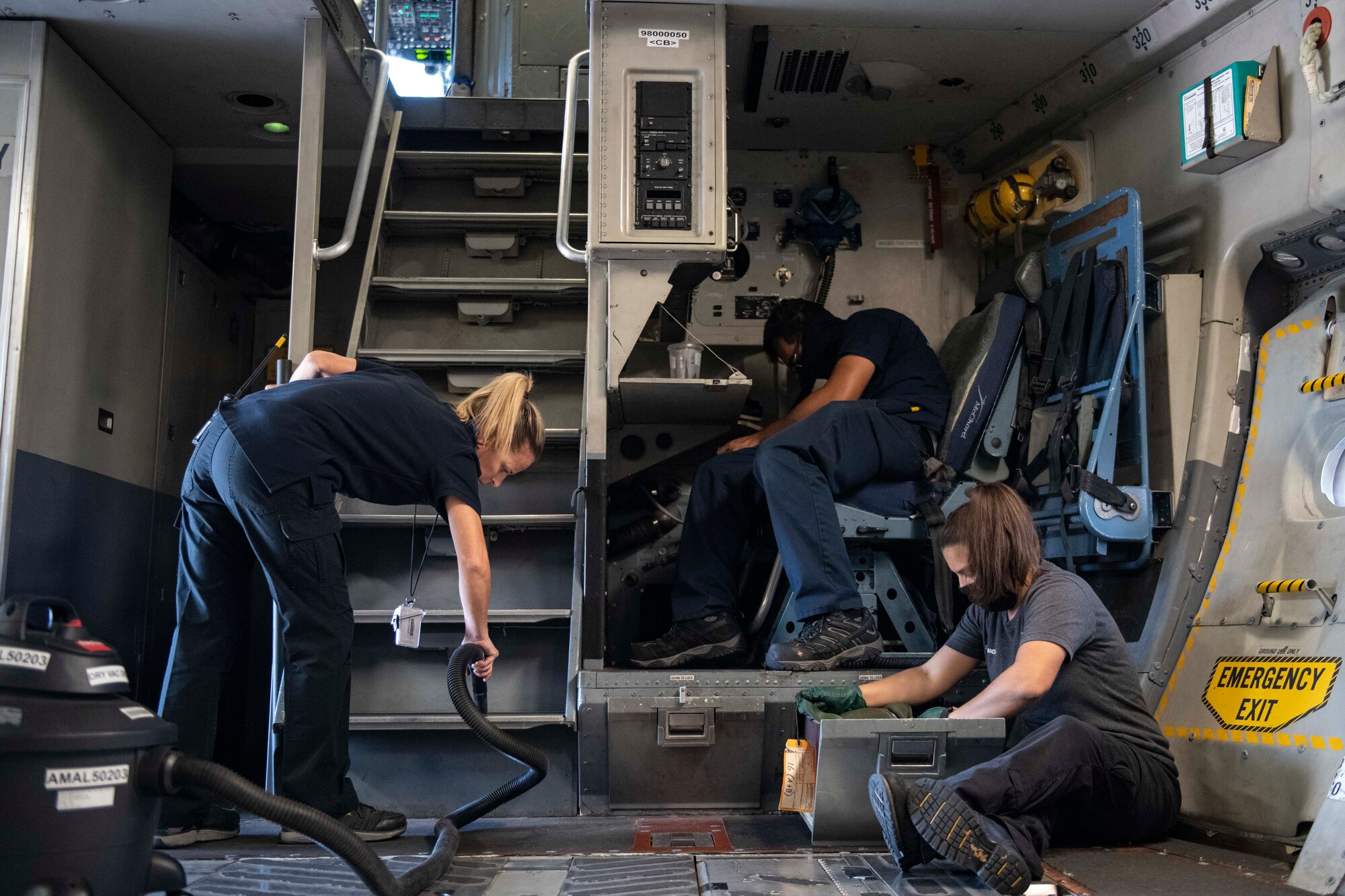 Aircraft attendants clean the inside of a C-17 Globemaster III.