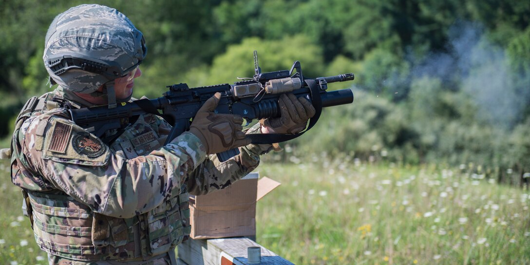 Senior Airman Dakota Gipe, 911th Security Forces Squadron fire team member, fires a M203 grenade launcher at Camp Dawson, West Virginia, Aug. 12, 2020.