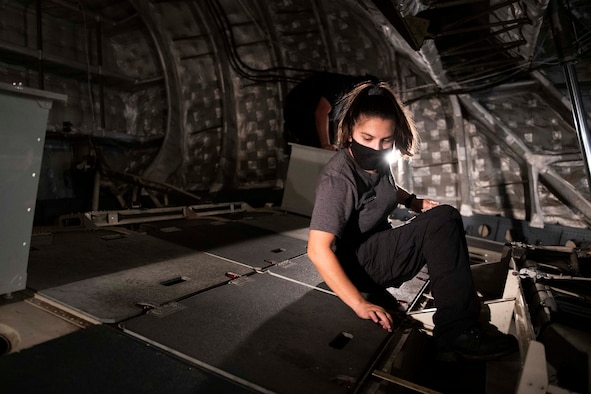 Aircraft attendants clean the inside of a C-17 Globemaster III.
