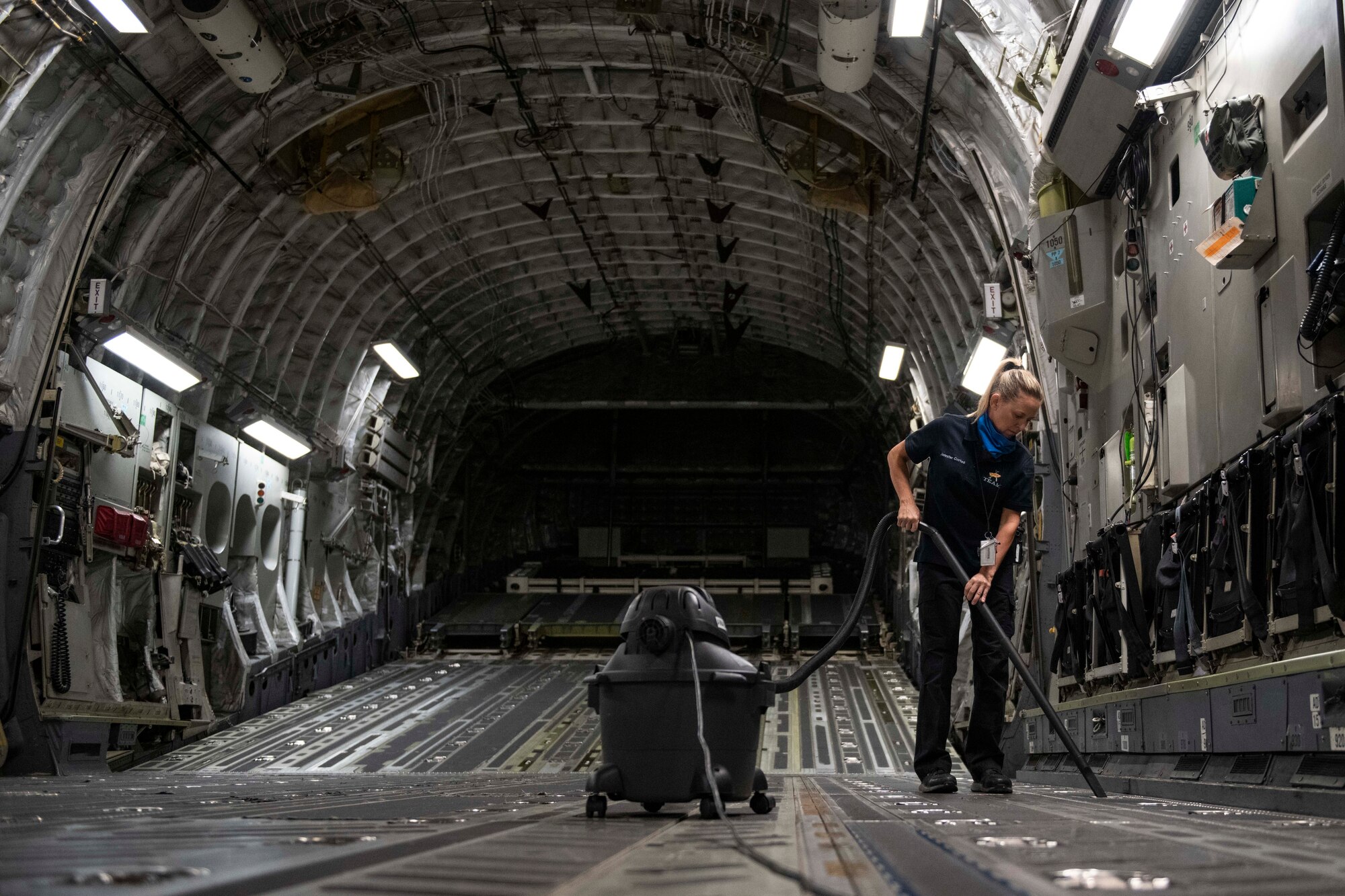 Aircraft attendants clean the inside of a C-17 Globemaster III.