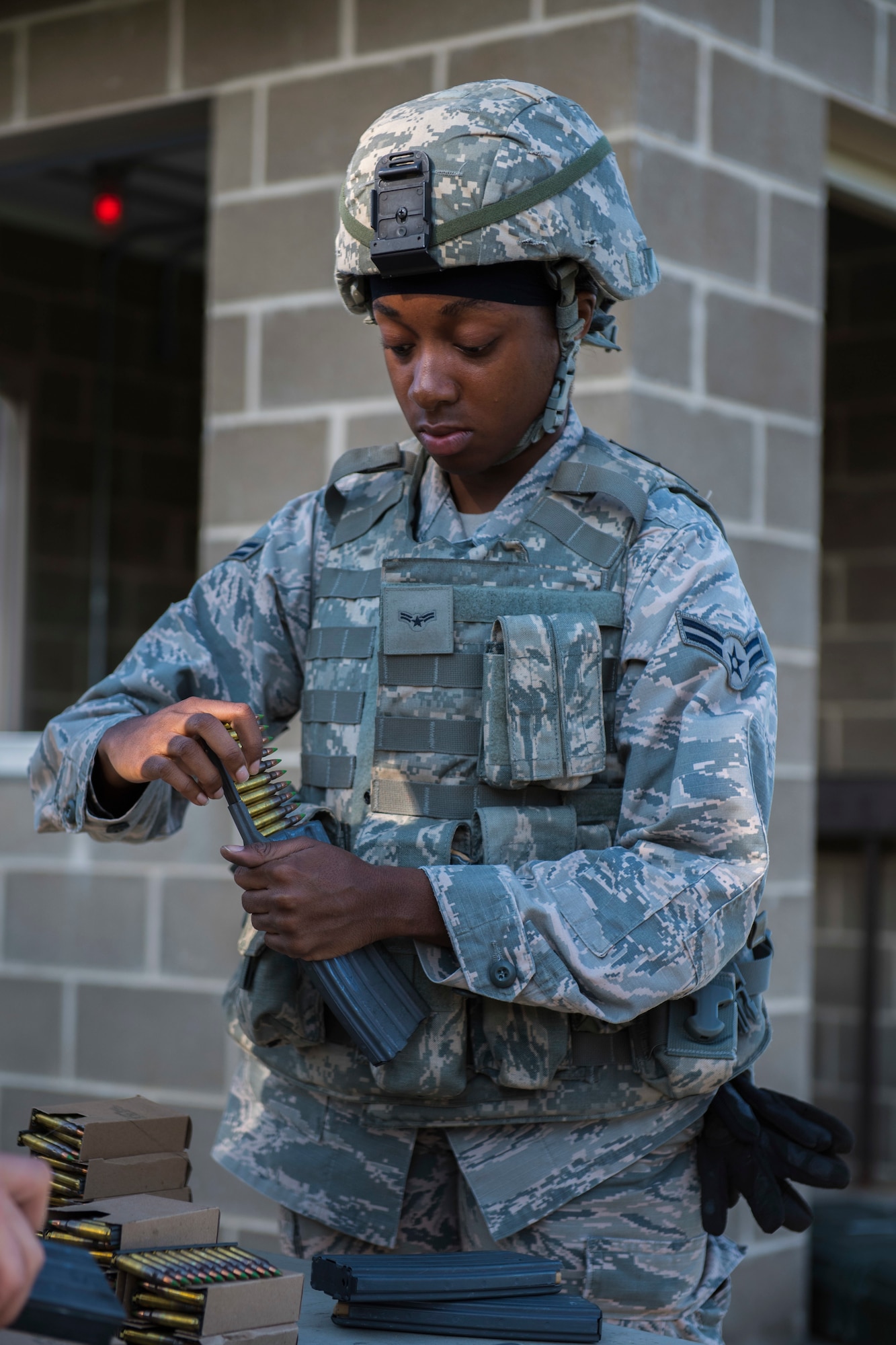 Airman First Class Margaret Asare, 911th Security Forces Squadron fire team member, loads 5.56 NATO rounds from a stripper clip into a M4 carbine magazine at Camp Dawson, West Virginia, Aug. 13, 2020.