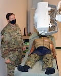 Staff Sgt. Karrie Prescott, a Medical Education and Training Campus radiologic technologist program instructor assigned to the U.S. Army Medical Center of Excellence at Joint Base San Antonio-Fort Sam Houston, checks the angle accuracy on the portable x-ray machine following student testing.