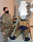 Staff Sgt. Karrie Prescott, a Medical Education and Training Campus radiologic technologist program instructor assigned to the U.S. Army Medical Center of Excellence at Joint Base San Antonio-Fort Sam Houston, checks the angle accuracy on the portable x-ray machine following student testing.