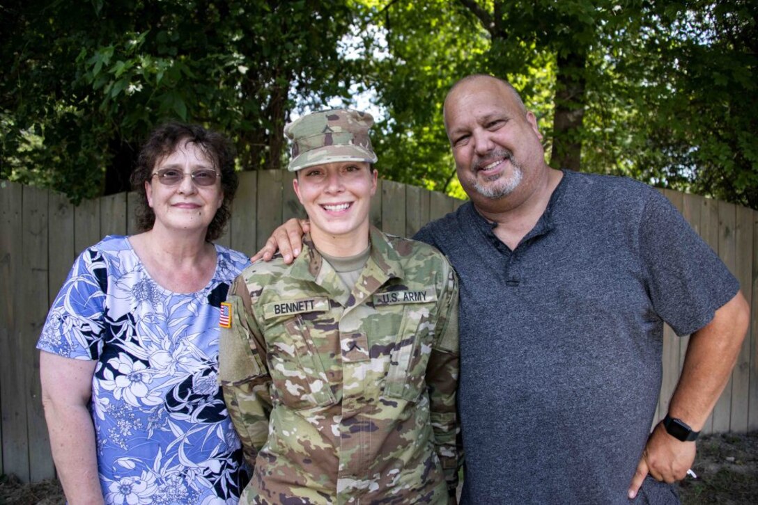 Pvt. Ana-Alicia Bennett poses for a photograph with her parents July 27, 2020, outside their home in Mechanicsville, Virginia.
