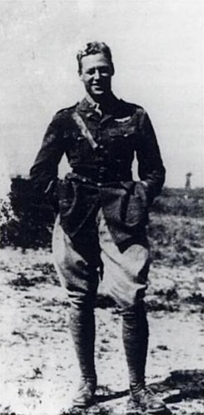 A man in an aviator uniform poses for a photo.