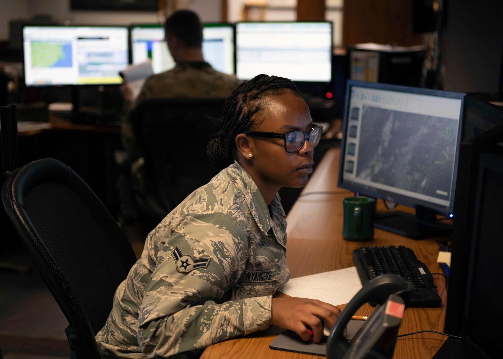 Weather forecaster from the Airman 1st Class Charlene Nyangere, 4th Operations Support Squadron weather flight  reviews the weather before briefing an F-15E Strike Eagle pilot at Seymour Johnson Air Force Base, North Carolina, June 10, 2020.