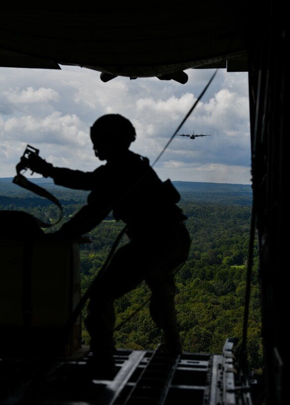 Staff Sgt. Nick Orcutt, a loadmaster with the 757th Airlift Squadron, Youngstown Air Reserve Station, Ohio, prepares cargo to drop out the back of a C-130H Hercules aircraft on Aug. 23, 2020, over a drop zone in the mountains of West Virginia. Five Air Force Reserve units from the 22nd Air Force and a West Virginia Air National Guard unit participated in Rally in the Valley, a multi-day C-130 training exercise under a distributed operations concept, Aug. 22-25, 2020. The exercise included cargo drops, high-altitude paratrooper drops, task force resupply and personnel extraction.