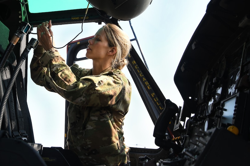 Capt. Jennie Seibert, 316th Wing executive officer and pilot, checks her gear before taking part in a female-led flyover above the District of Columbia, Aug. 26, 2020.